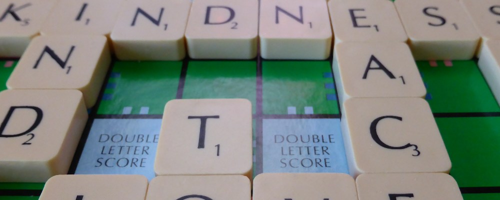 scrabble tiles on a board spelling out the words star, road, to love, kindness, find, peace