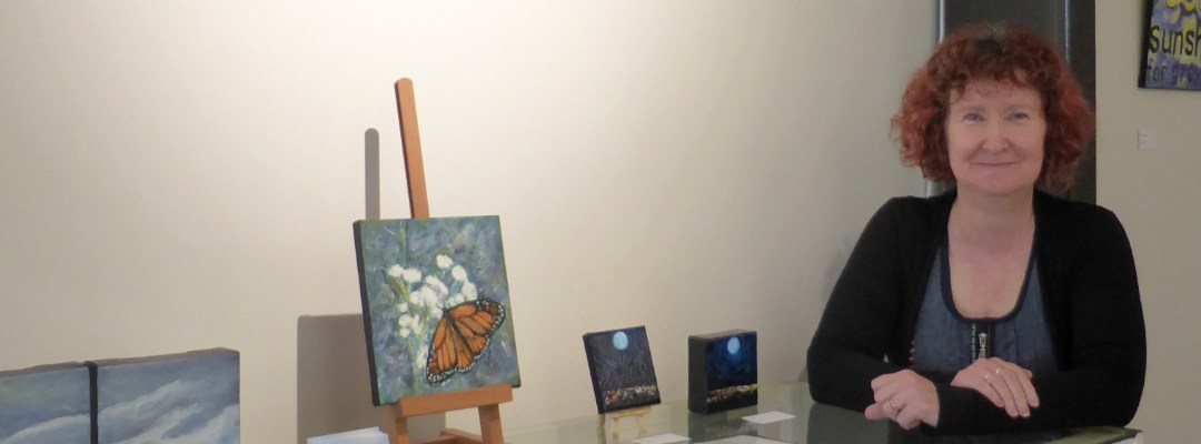 the artist, Anna Cull, at the exhibition with her paintings