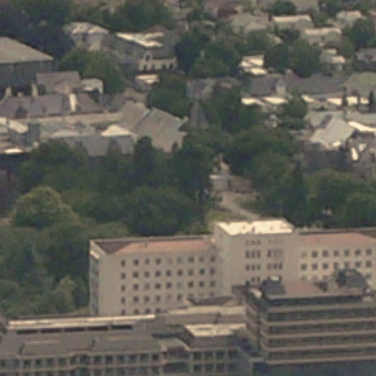 the photo reference used to create the painting, with Christchurch Hospital in the foreground, an abundance of green trees, and the Arts Centre in the background